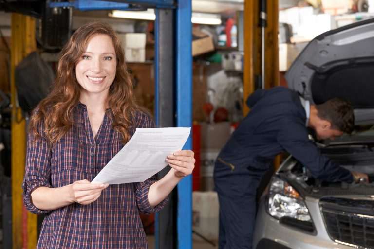 Female Customer In Auto Repair Shop Satisfied With Bill For Car